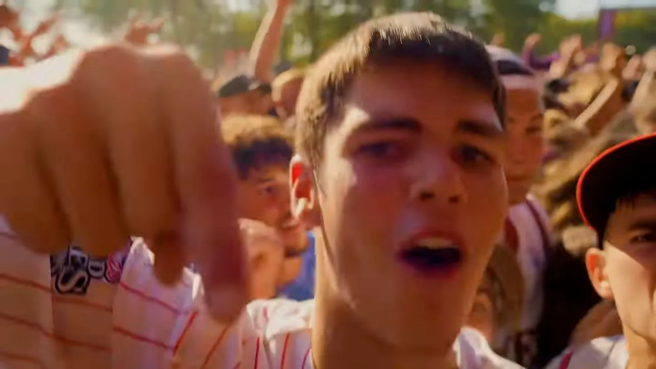 Close-up of person in dense crowd at nighttime concert or party event