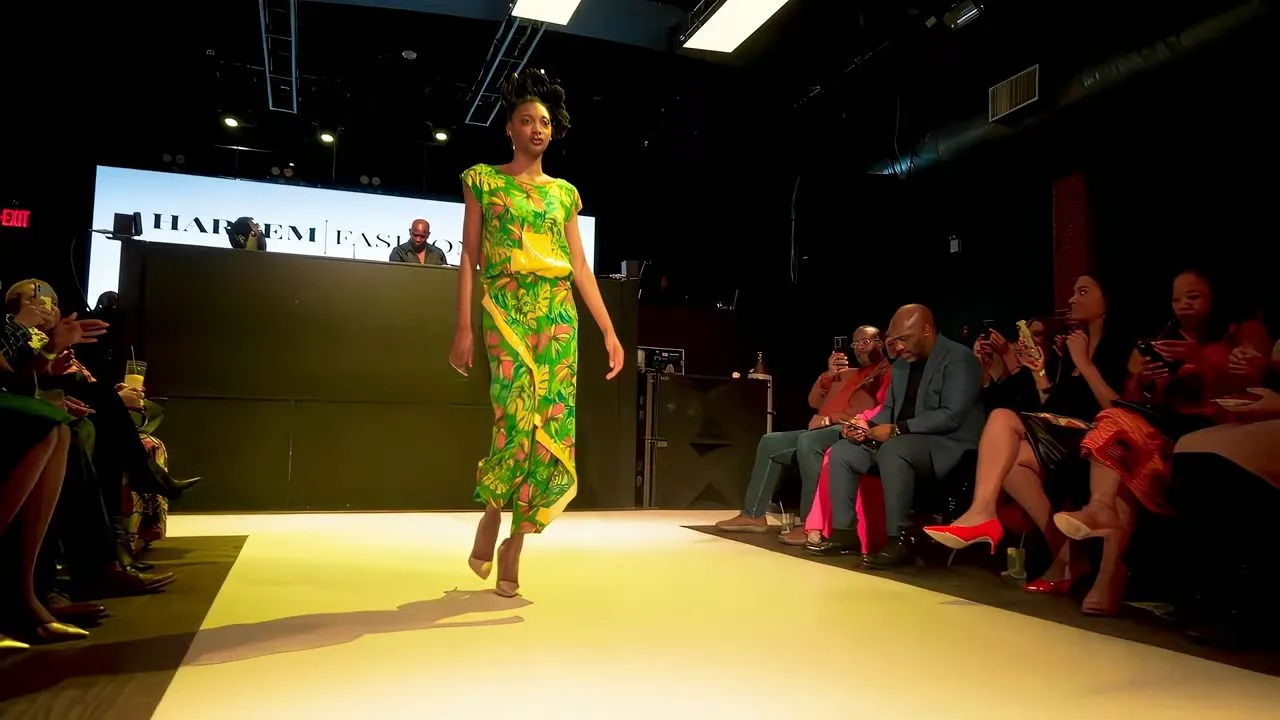 Fashion runway show, model walking illuminated catwalk with seated audience