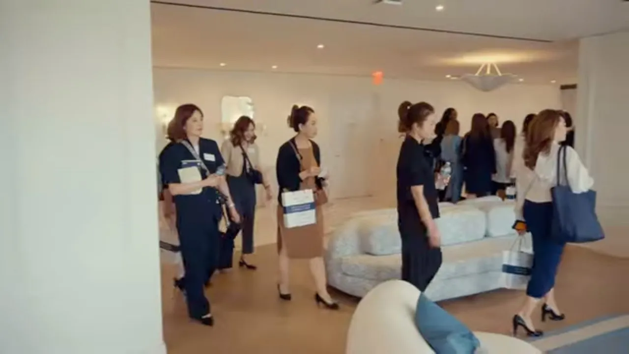 Well-dressed people mingling in bright modern indoor lounge with sofas