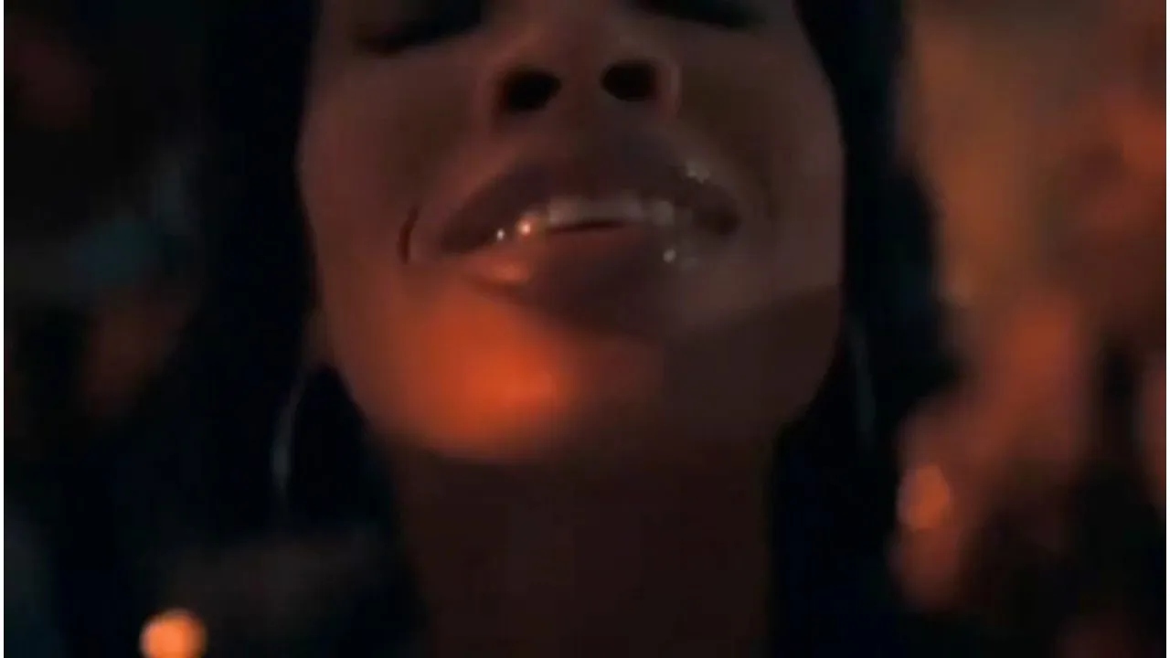 Close-up of a face lit by warm orange light at night