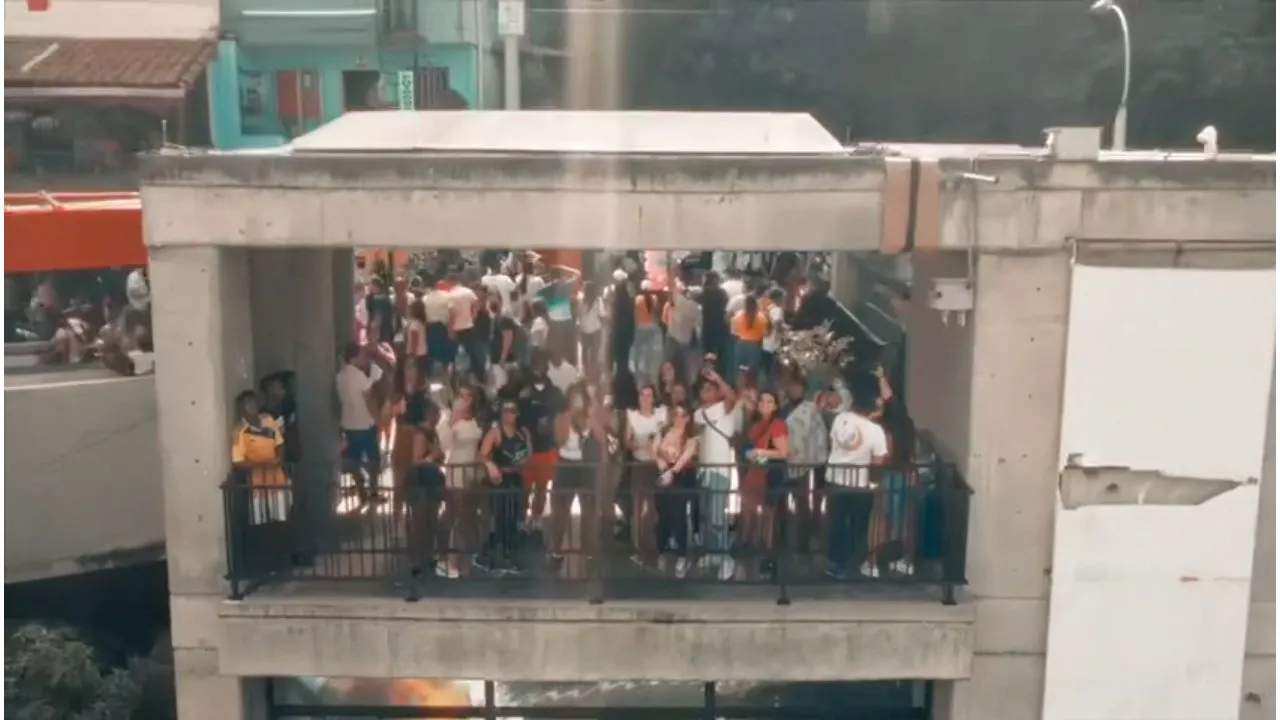 Crowd of people packed on building balcony at outdoor daytime event
