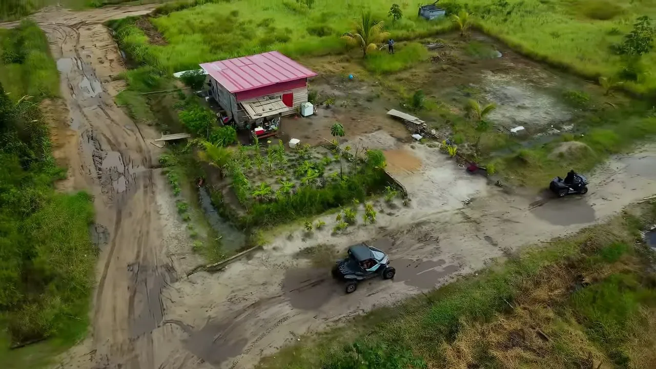 Aerial drone view of rural landscape with dirt roads and small building