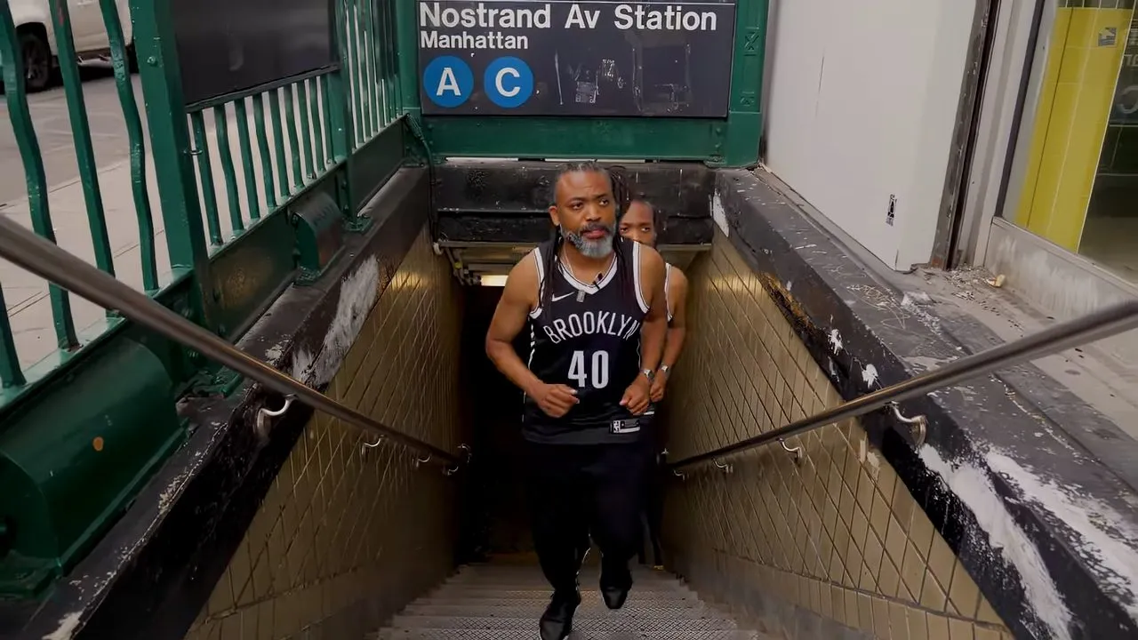 Person in basketball jersey ascending Nostrand Av subway station stairs