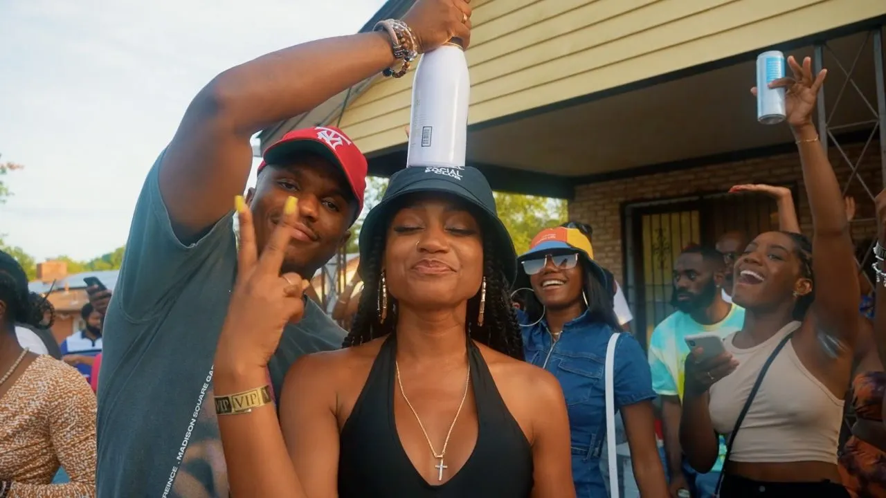 People posing and dancing at outdoor backyard party, pouring drinks, sunny daytime