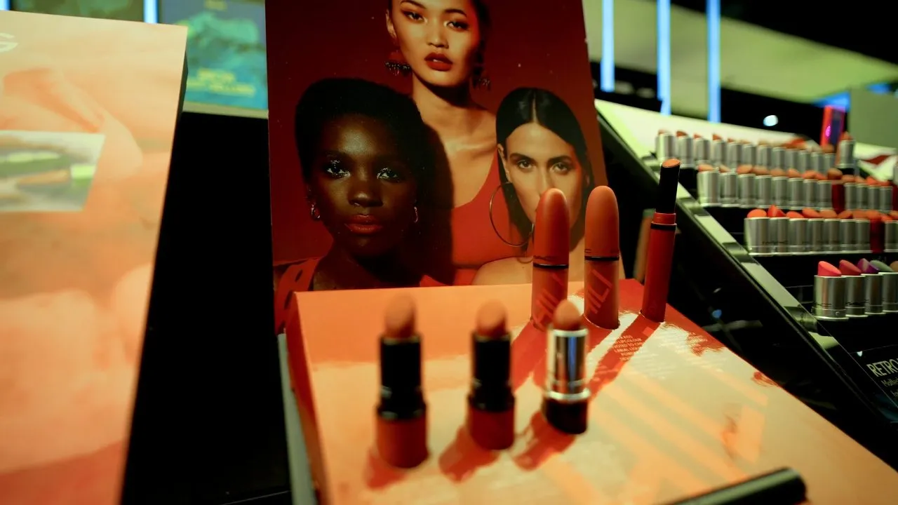 MAC cosmetics display with lipsticks and beauty campaign poster in retail store